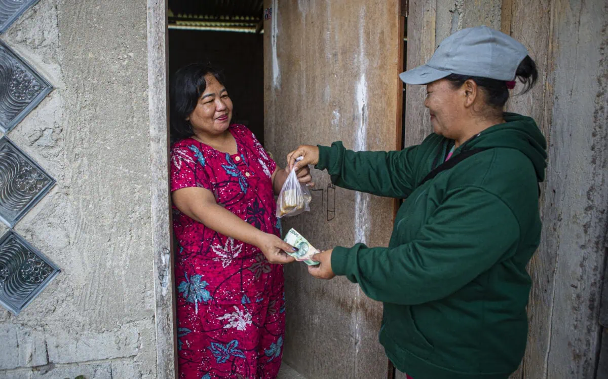 a woman handing money to a woman